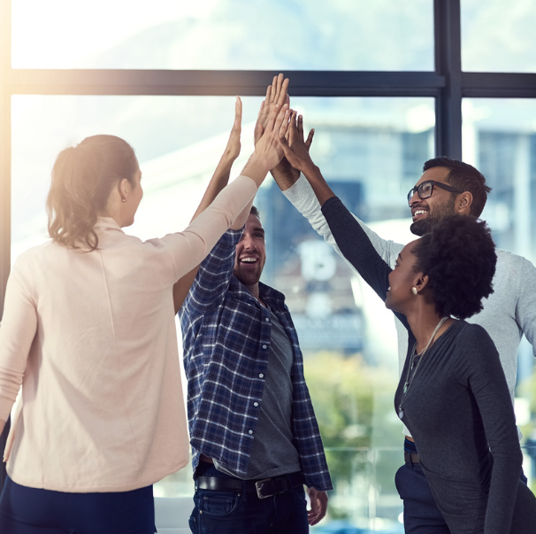 Team of four high fiving